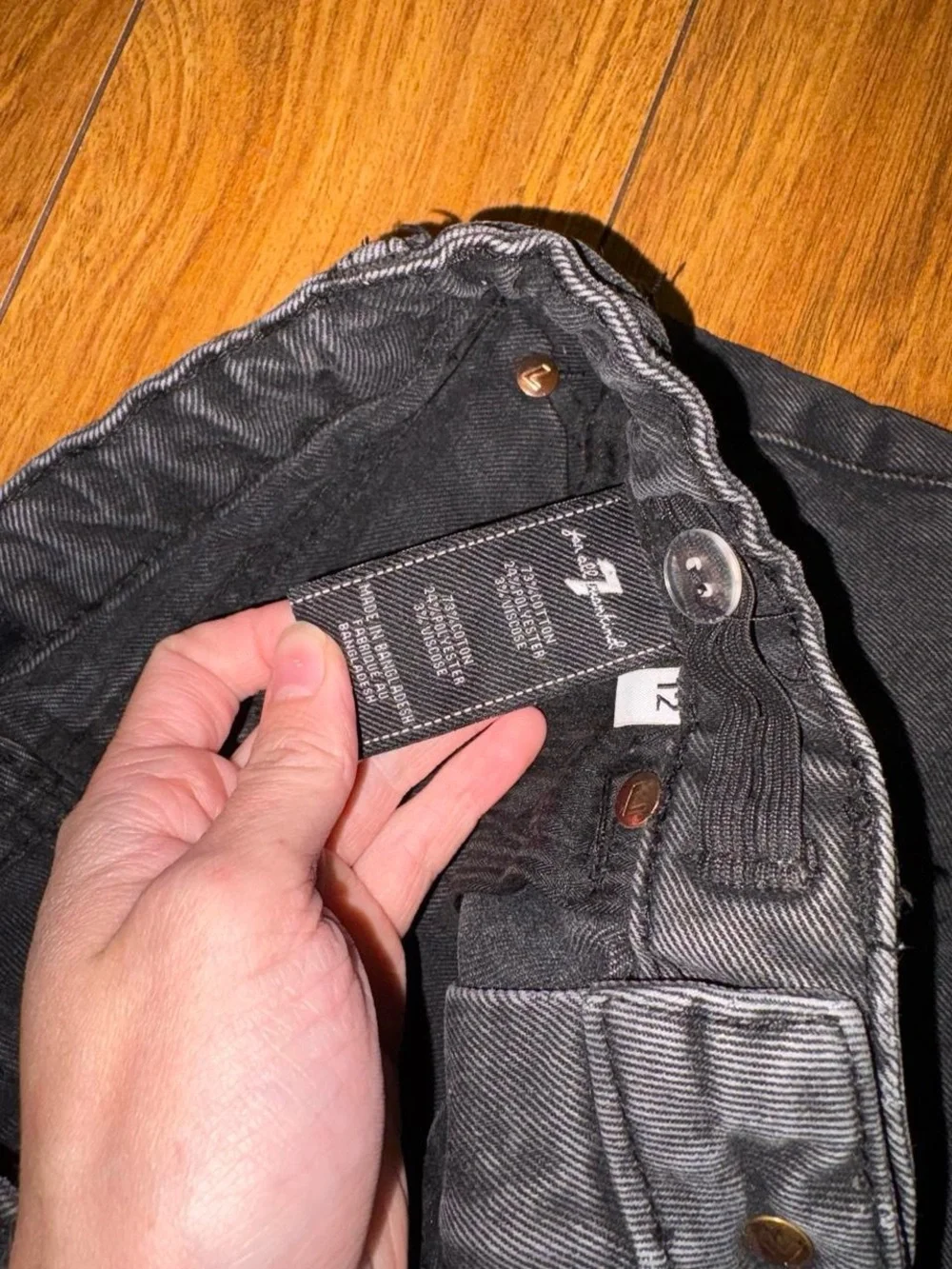 Black denim shorts with a distressed look
